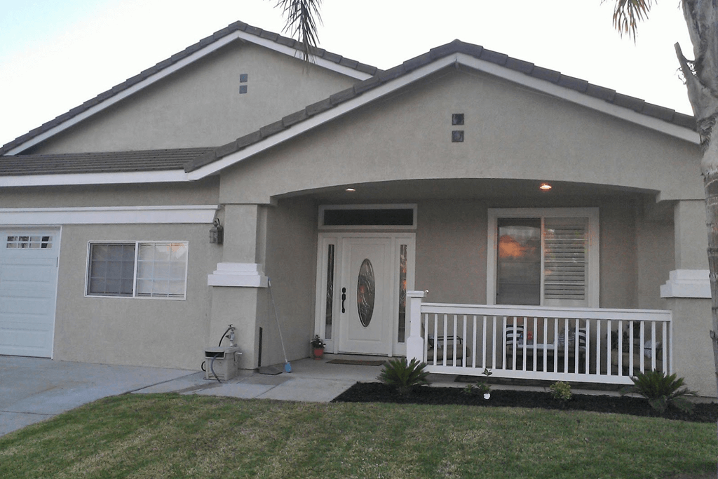 Adu construction in los angeles with pretty pink house with neat white railings outside and overall appealing aesthetic.
